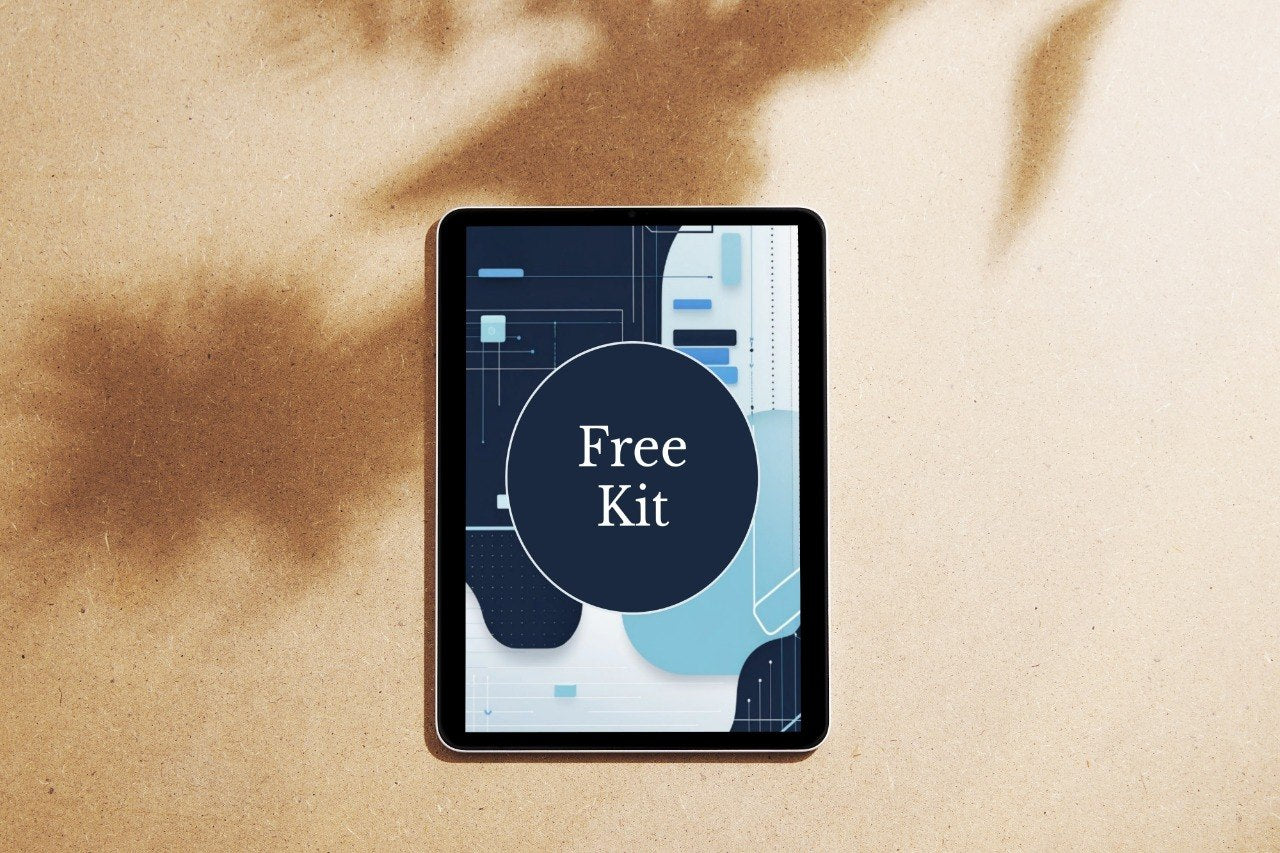 A tablet device lying on a beige textured surface with soft brown shadows cast across it. The screen displays a dark abstract graphic with a large dark circle and the words 'Free Kit' in white.